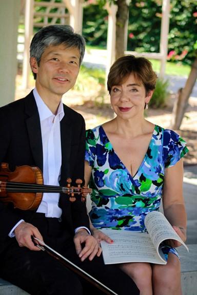 Musicians holding violin and musical book